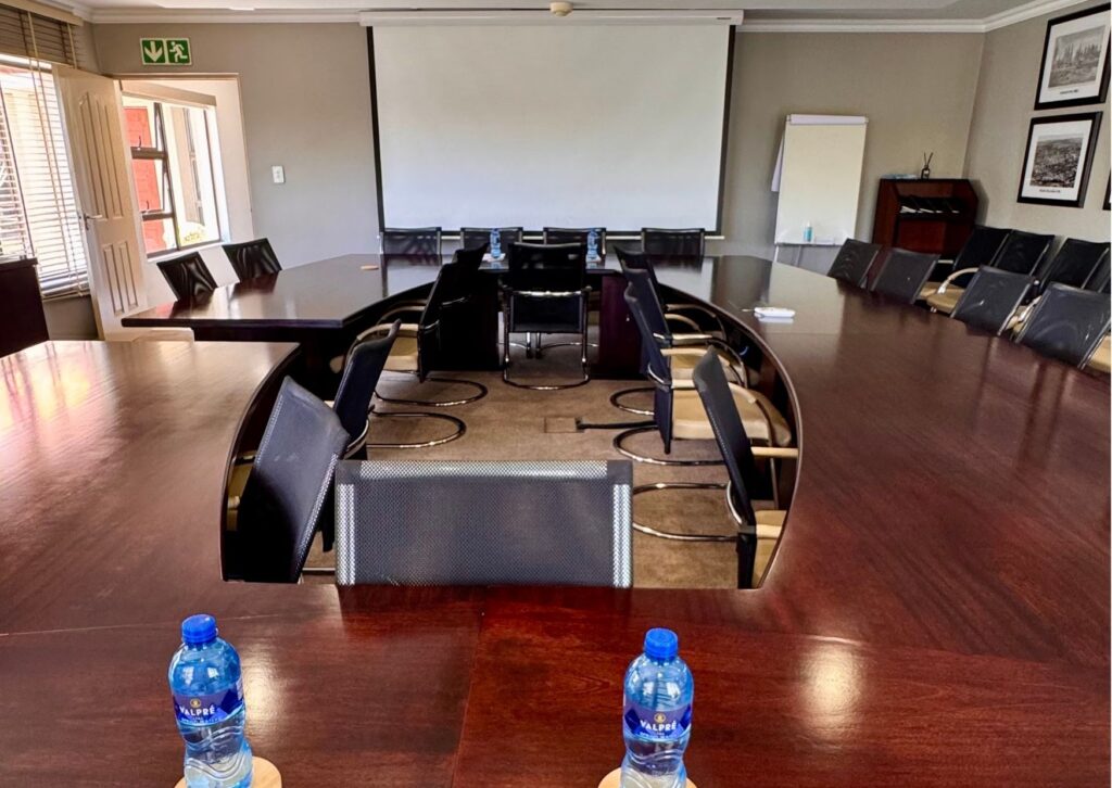 An intimate, fully equipped conference venue at The African Penguin, perfectly configured for focused team strategy sessions and workshops.